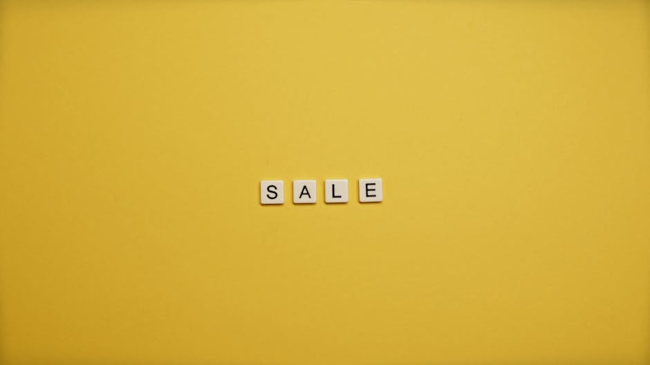 Single word 'SALE' spelled with tiles on a bright yellow background, ideal for advertising.