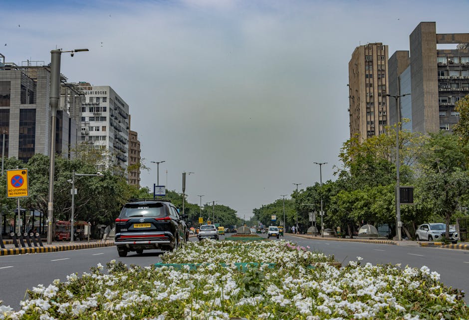 Explore the urban architecture and vibrant street life of New Delhi, India, captured in a dynamic street scene.